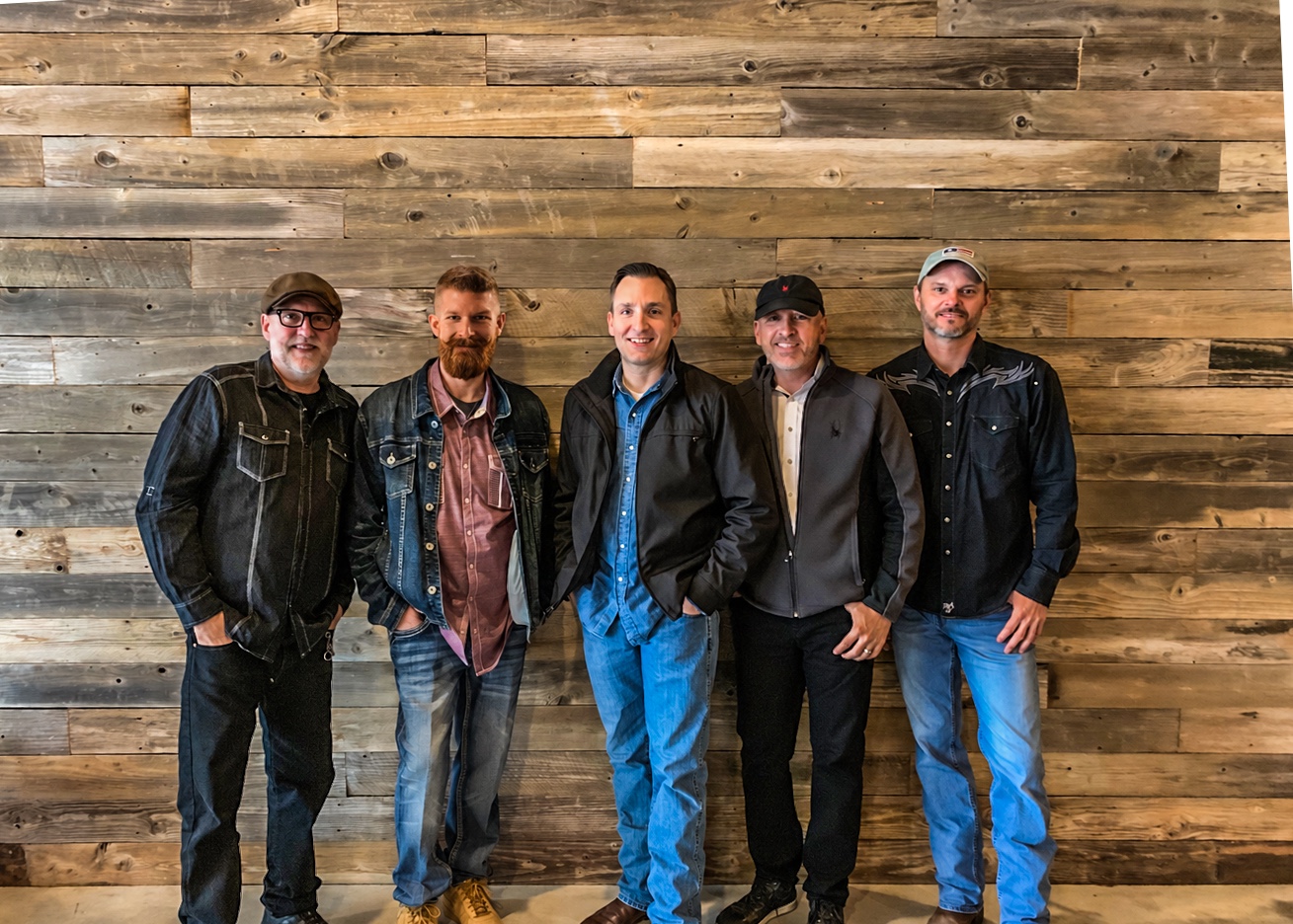 The five members of 6 Miles to Mixon standing together against a wooden wall